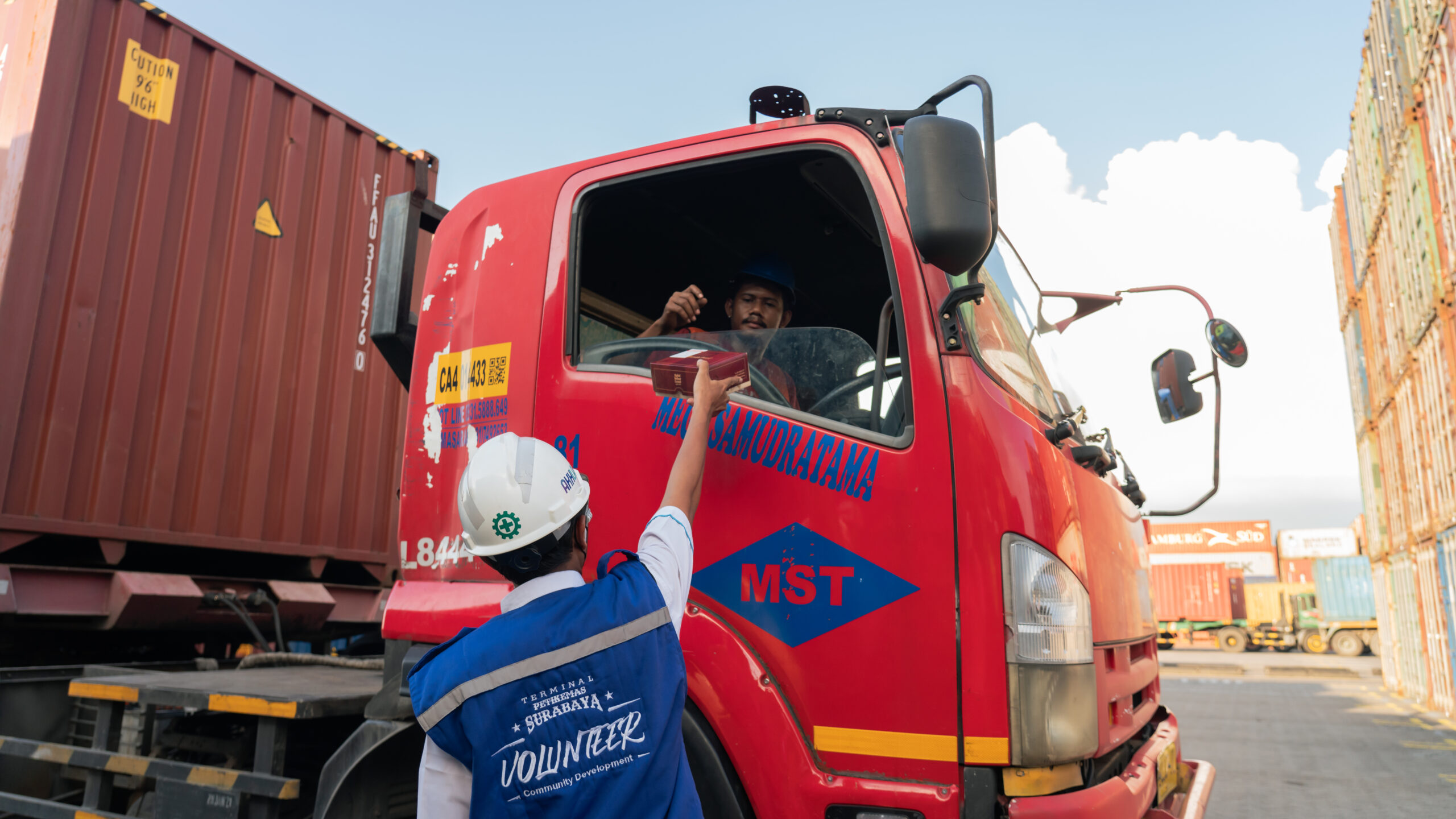 Pekerja TPS Membagikan Takjil Buka Puasa kepada Pengemudi Truk di Container Yard TPS
